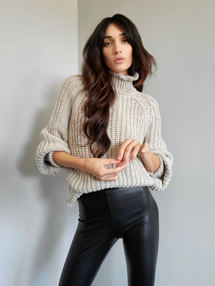 ribbed, chunky knit turtleneck sweater featuring slight balloon sleeves and a funnel neck in grey