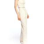 Mid-rise, wide leg pants with pleated front, side pockets, faux back pockets and belt loops in ivory