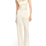 Mid-rise, wide leg pants with pleated front, side pockets, faux back pockets and belt loops in ivory