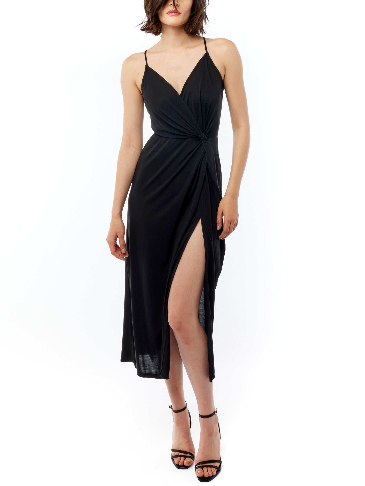 midi dress with a surplice top, gathered twist front, adjustable spaghetti straps and side slit in black