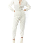 jumpsuit featuring a collared, button-front, long, cuffed sleeves, elasticized waist and bottom cuffs in ivory