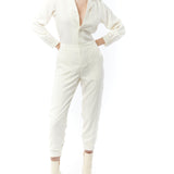 jumpsuit featuring a collared, button-front, long, cuffed sleeves, elasticized waist and bottom cuffs in ivory