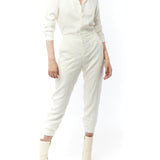 jumpsuit featuring a collared, button-front, long, cuffed sleeves, elasticized waist and bottom cuffs in ivory