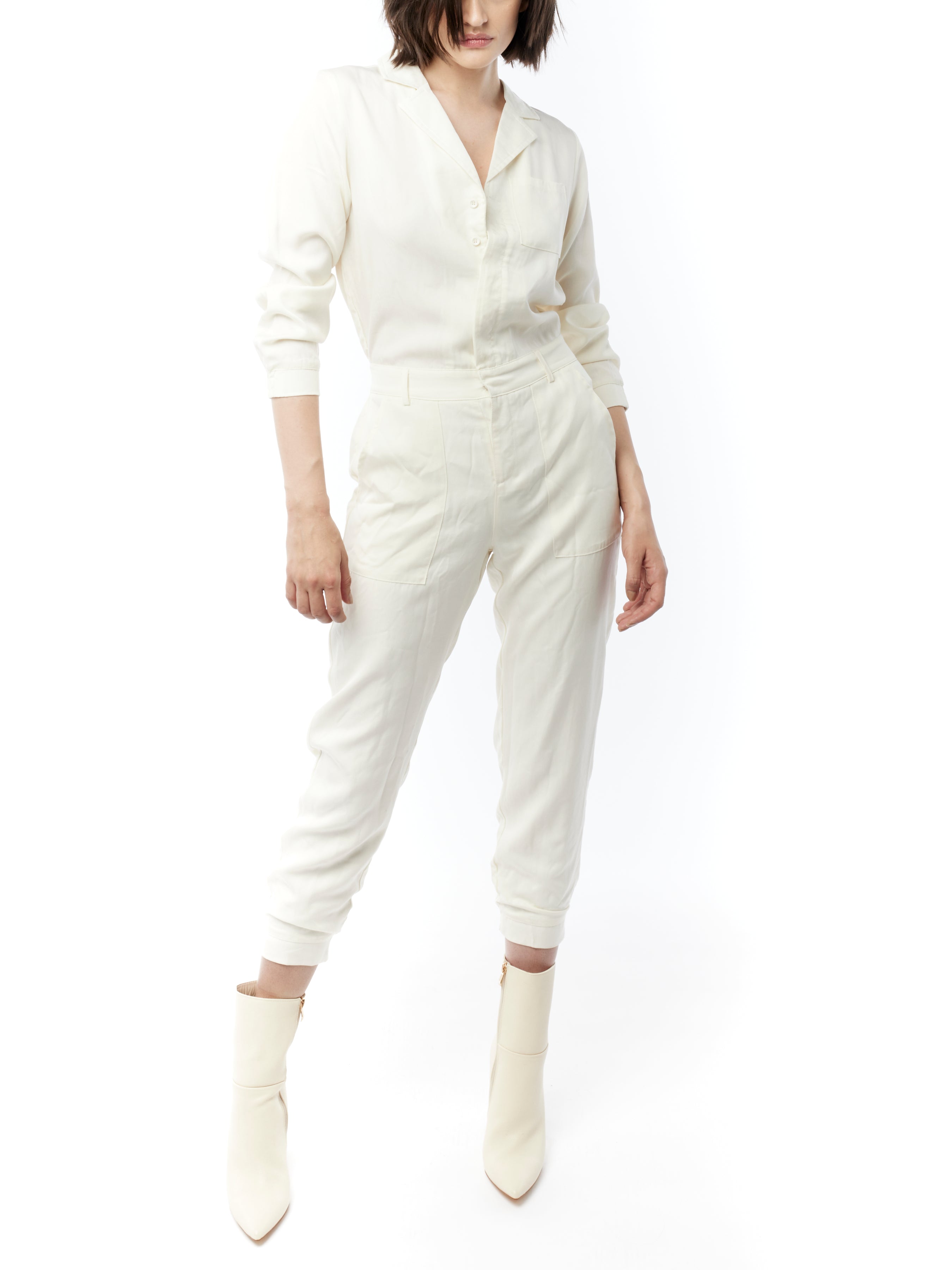 jumpsuit featuring a collared, button-front, long, cuffed sleeves, elasticized waist and bottom cuffs in ivory