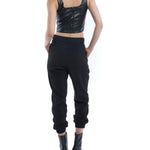 pleated pant with a tapered leg, elasticized cuffs, zip and button closure and side pockets in black