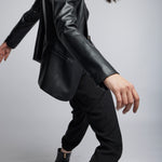 faux leather blazer cut with front pockets, back vent and button closure in black