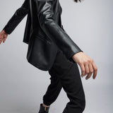 faux leather blazer cut with front pockets, back vent and button closure in black
