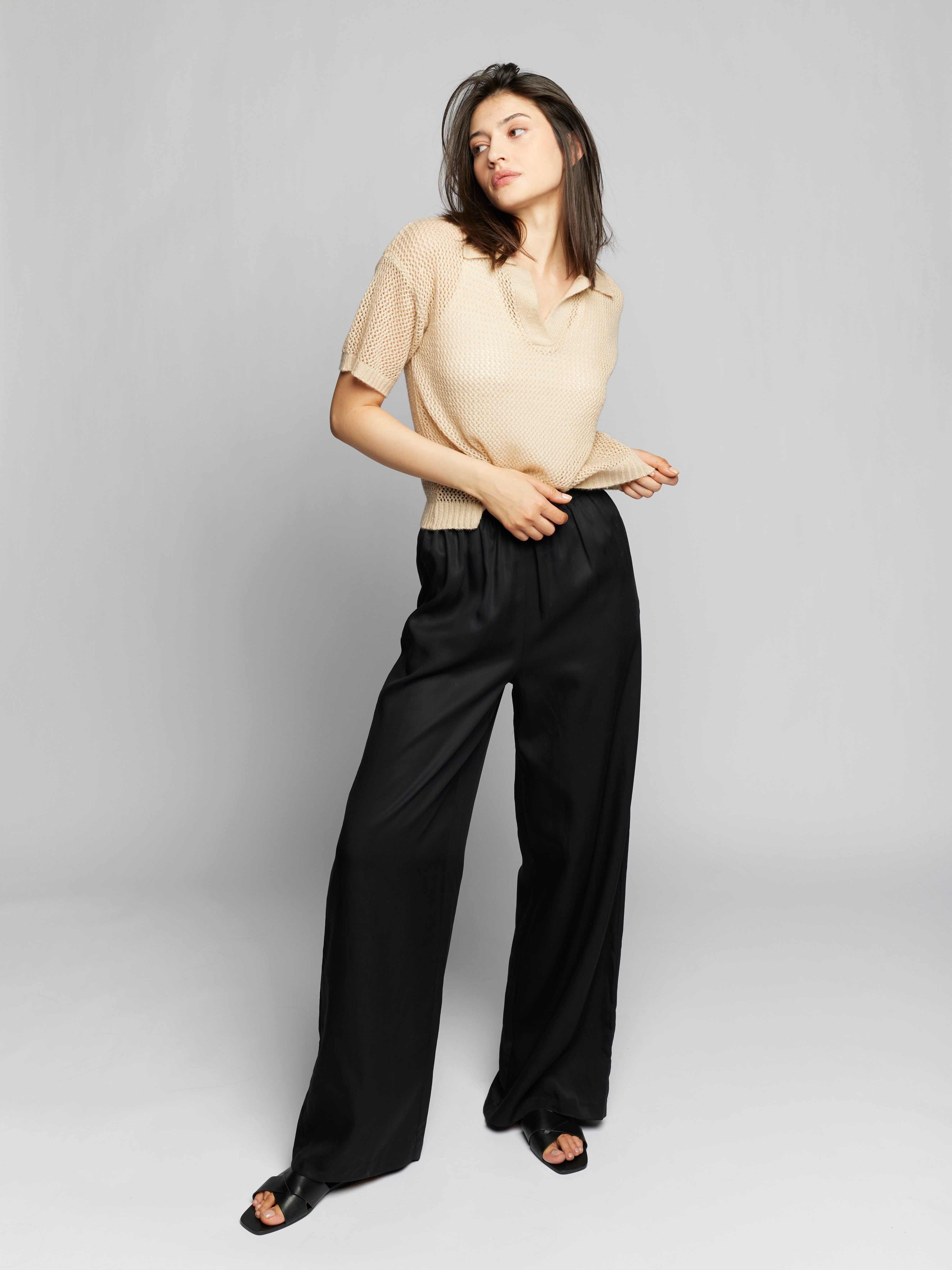 breezy open knit, short sleeve, collared top with a chic notch-neck and ribbed detailing on hem, sleeves and collar
