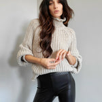 ribbed, chunky knit turtleneck sweater featuring slight balloon sleeves and a funnel neck in grey