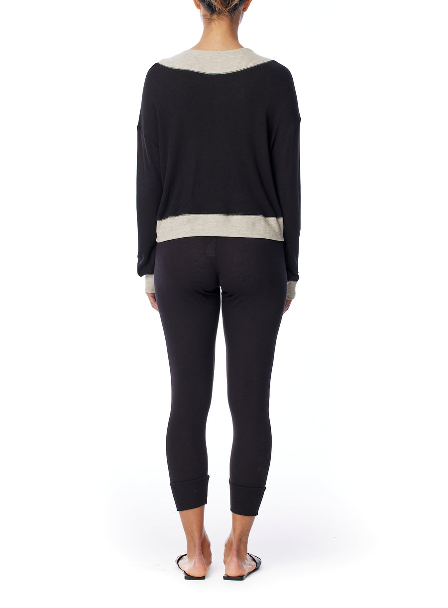 Long sleeve thermal top with a relaxed fit, ballet neck with contrasting hem, cuffs and bib in black