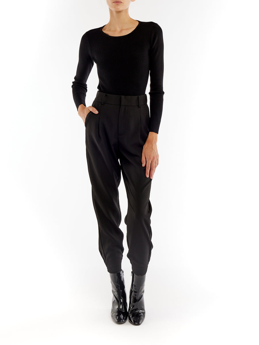 pleated pant with a tapered leg, elasticized cuffs, zip and button closure and side pockets