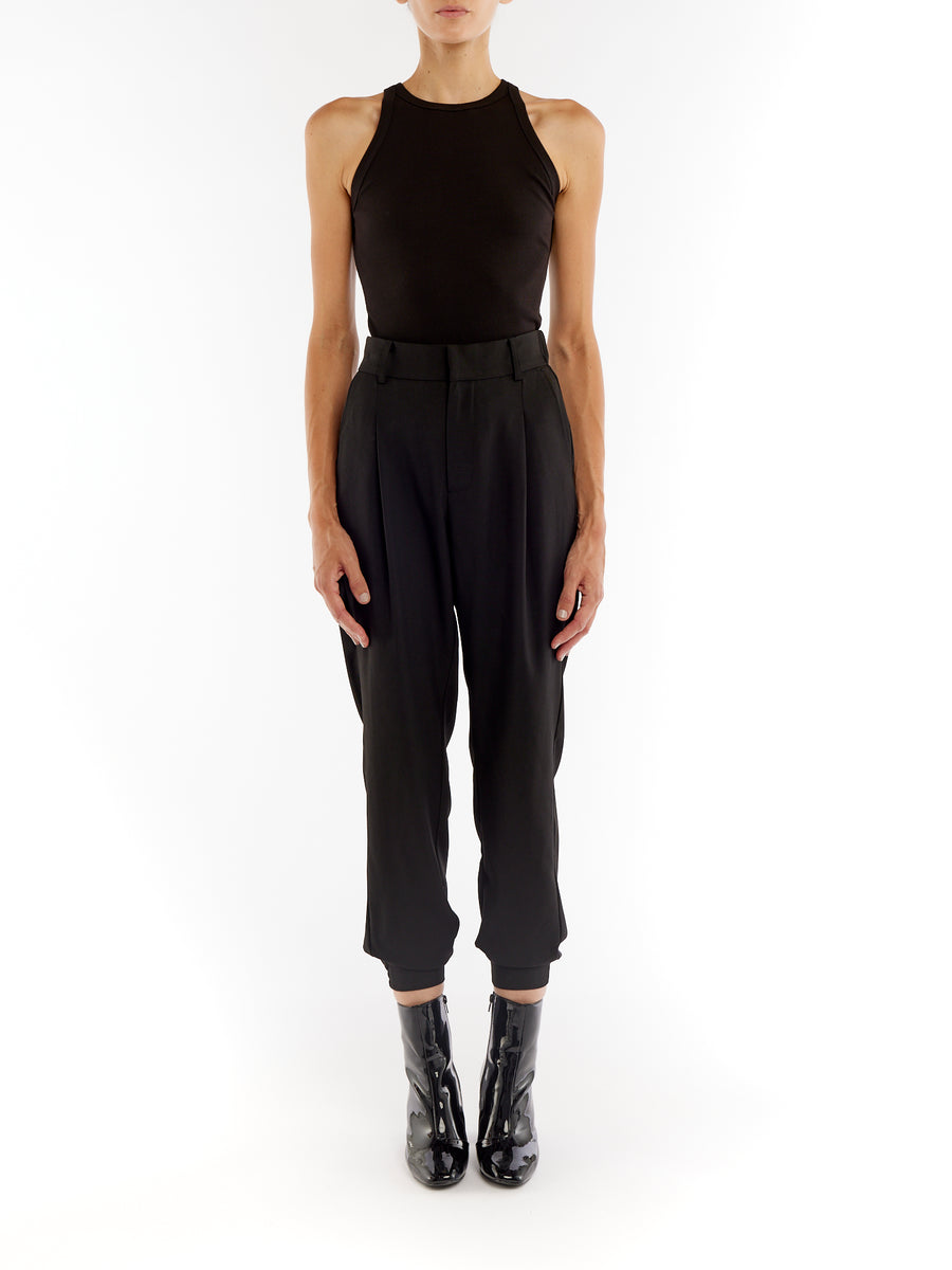 pleated pant with a tapered leg, elasticized cuffs, zip and button closure and side pockets