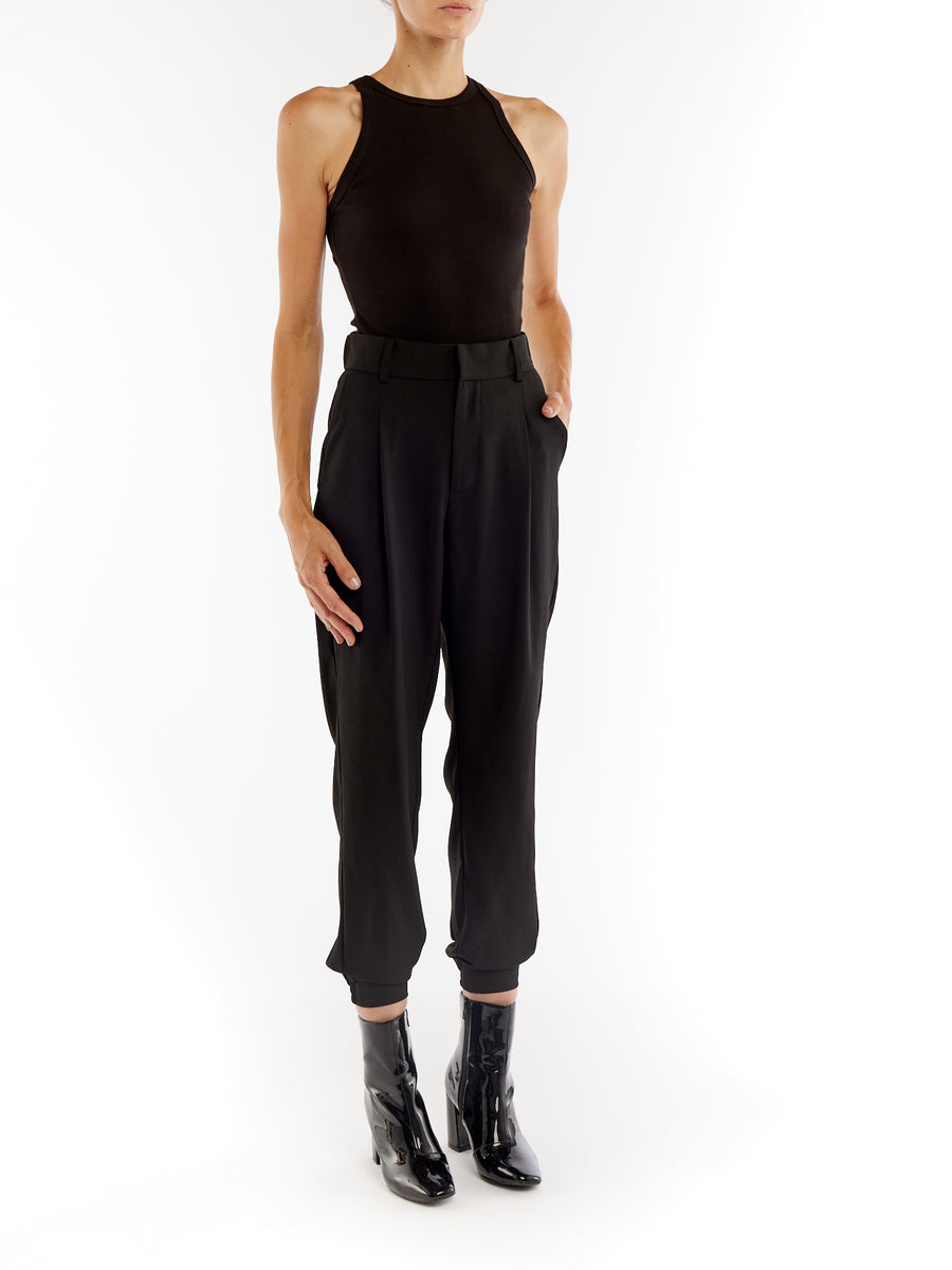 pleated pant with a tapered leg, elasticized cuffs, zip and button closure and side pockets