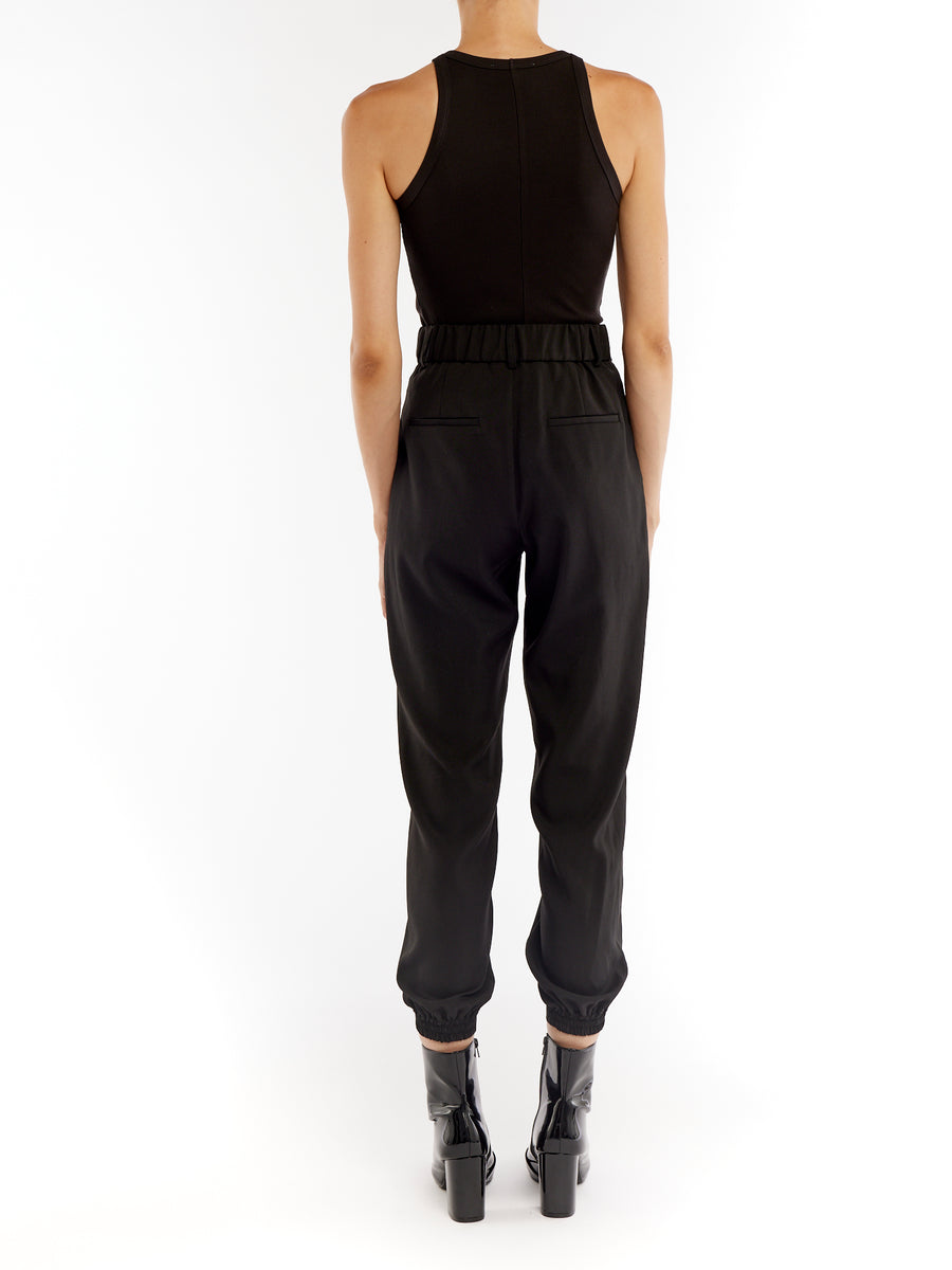 pleated pant with a tapered leg, elasticized cuffs, zip and button closure and side pockets