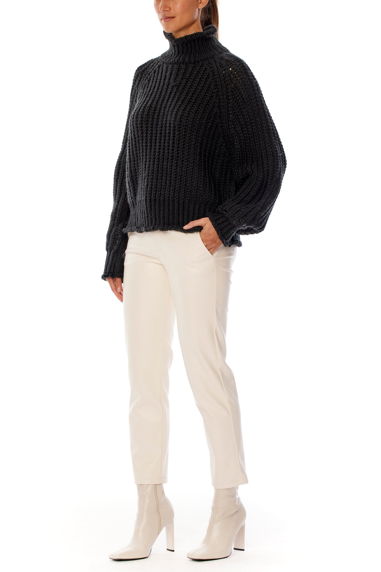 ribbed, chunky knit turtleneck sweater featuring slight balloon sleeves and a funnel neck in black