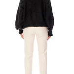 ribbed, chunky knit turtleneck sweater featuring slight balloon sleeves and a funnel neck in black