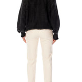 ribbed, chunky knit turtleneck sweater featuring slight balloon sleeves and a funnel neck in black