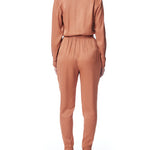 vegan silk jumpsuit with a cross over front, tapered leg, long sleeves, tie waist & side pockets