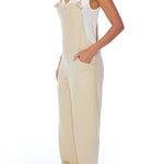 relaxed overalls with knotted front shoulder straps, racer back shoulder straps and pockets in creme