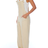 relaxed overalls with knotted front shoulder straps, racer back shoulder straps and pockets in creme