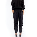 jumpsuit featuring a collared, button-front, long, cuffed sleeves, elasticized waist and bottom cuffs in black