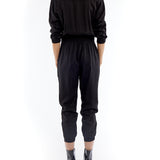 jumpsuit featuring a collared, button-front, long, cuffed sleeves, elasticized waist and bottom cuffs in black
