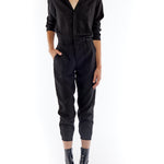 jumpsuit featuring a collared, button-front, long, cuffed sleeves, elasticized waist and bottom cuffs in black