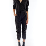 jumpsuit featuring a collared, button-front, long, cuffed sleeves, elasticized waist and bottom cuffs in black