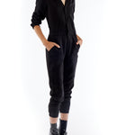 jumpsuit featuring a collared, button-front, long, cuffed sleeves, elasticized waist and bottom cuffs in black