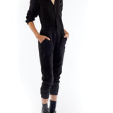 jumpsuit featuring a collared, button-front, long, cuffed sleeves, elasticized waist and bottom cuffs in black
