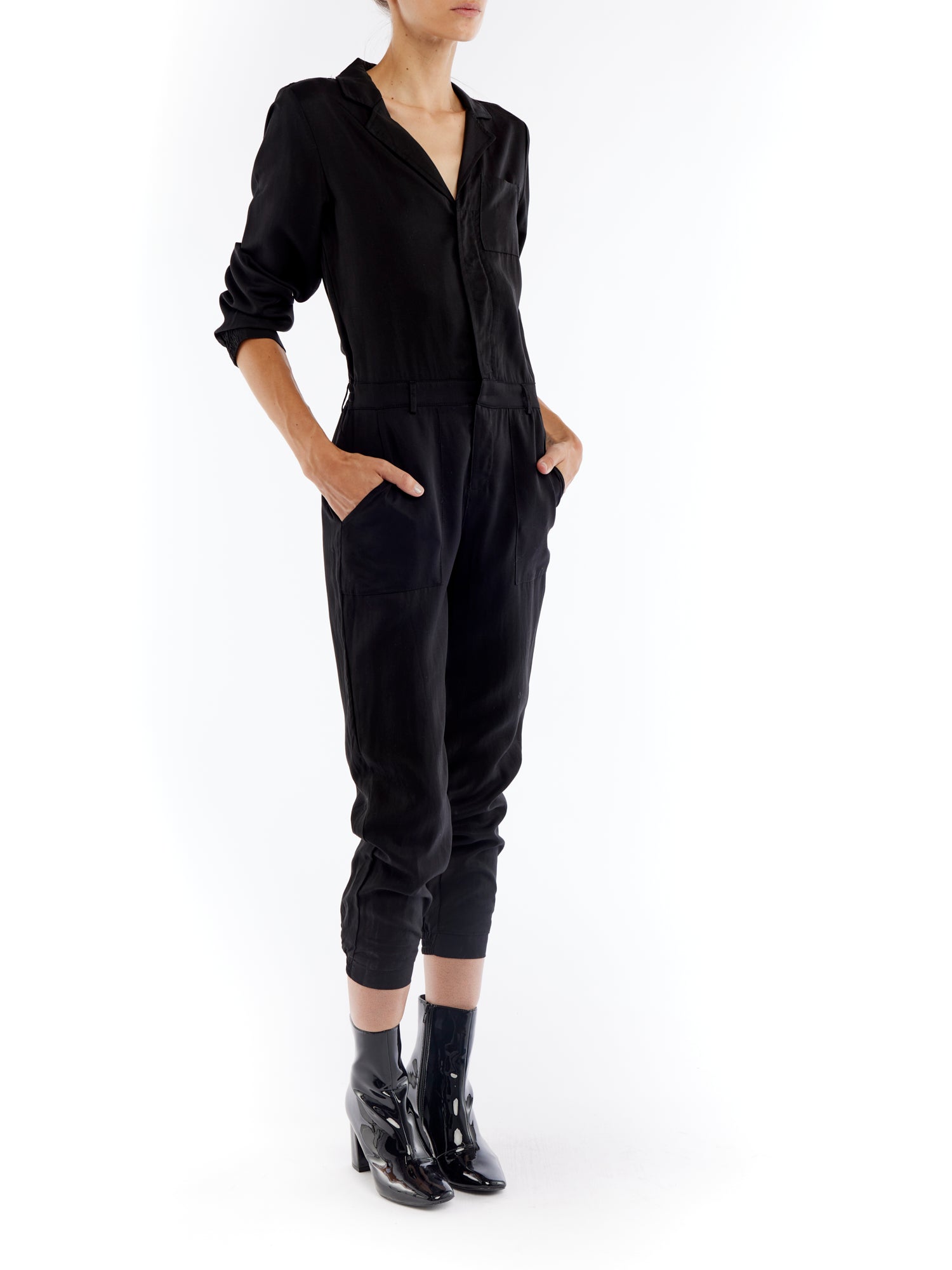 jumpsuit featuring a collared, button-front, long, cuffed sleeves, elasticized waist and bottom cuffs in black